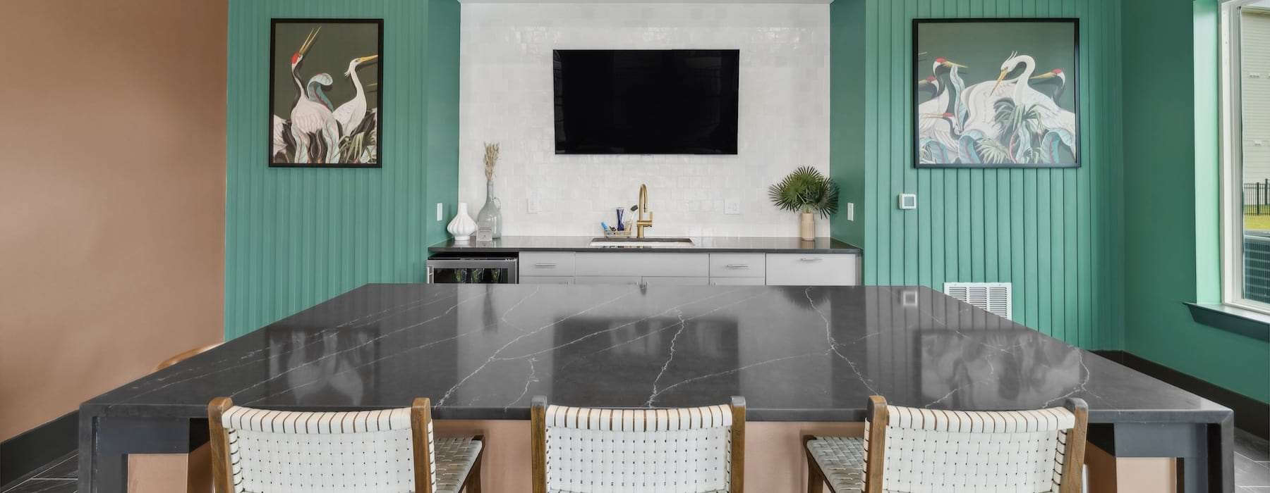 a clubroom kitchen with a large island and chairs