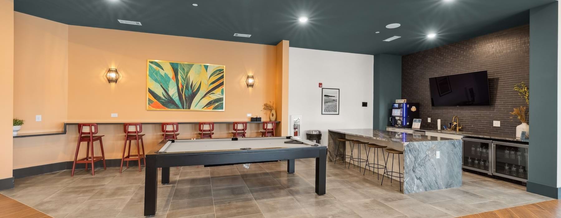 a clubroom with a pool table and chairs