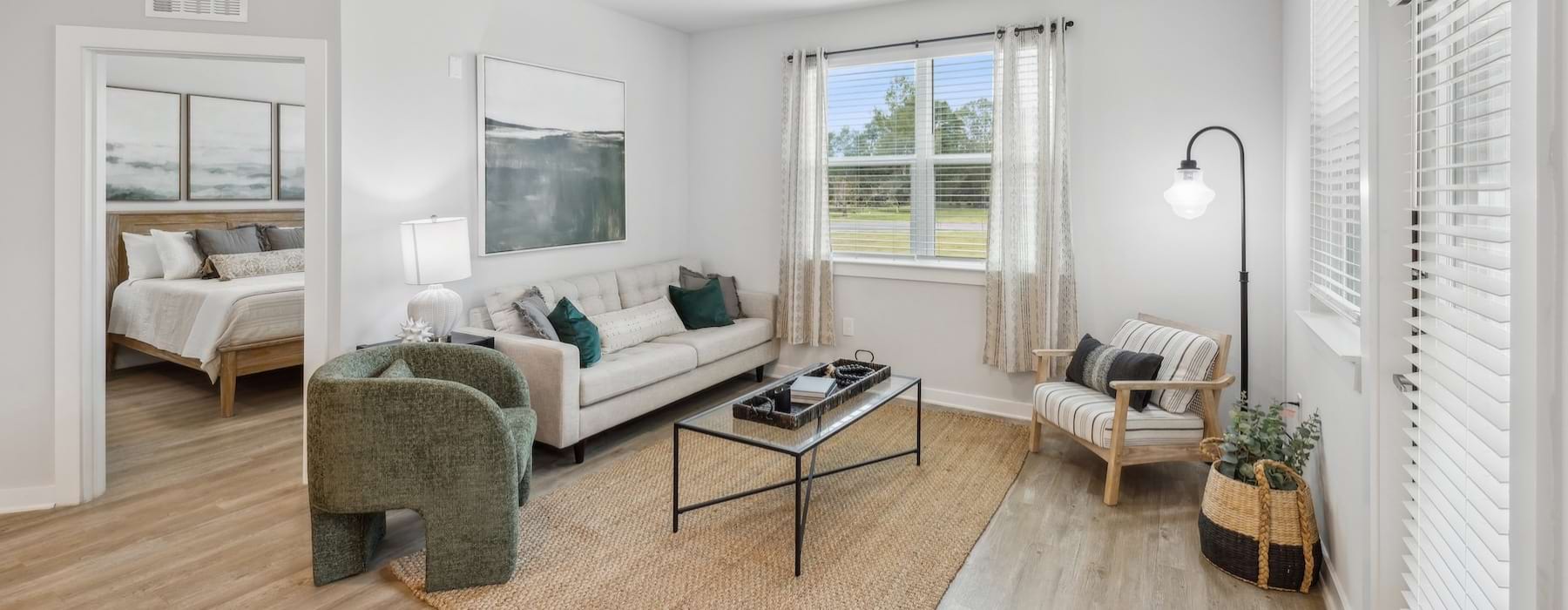 a living room with a wood floor, a couch and chairs